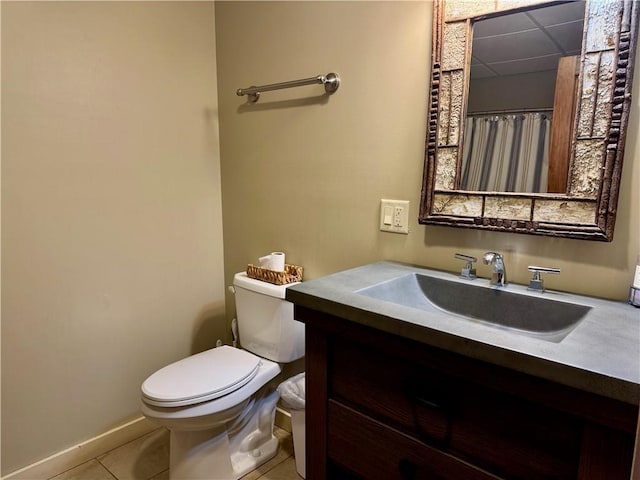 23310 Clam Lake Rd, Clam Lake, WI 54517 - bathroom featuring baseboards, a drop ceiling, toilet, tile patterned flooring, and vanity