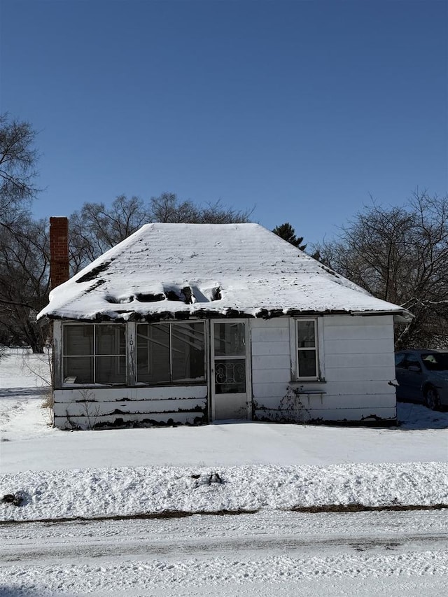 view of front of home featuring a chimney