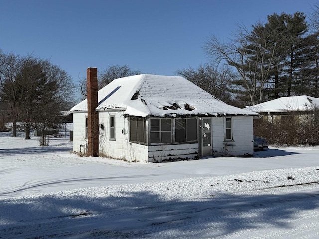 bungalow-style home with a chimney