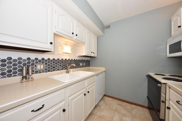 kitchen with light countertops, backsplash, white cabinets, a sink, and white appliances