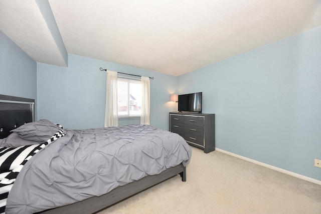 bedroom featuring baseboards and light colored carpet