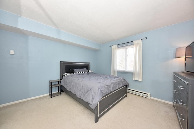 bedroom with a baseboard heating unit, light colored carpet, and baseboards