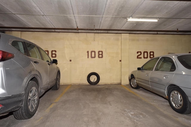 parking deck featuring concrete block wall