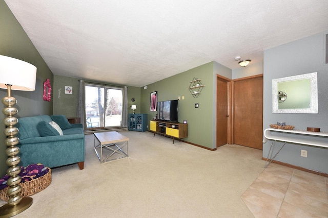 living room featuring light carpet, a textured ceiling, and baseboards