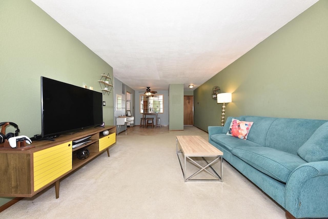 carpeted living area featuring a ceiling fan