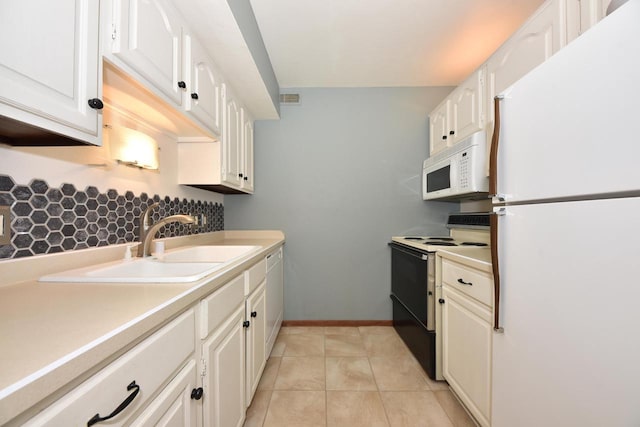 kitchen with white appliances, a sink, white cabinets, light countertops, and tasteful backsplash