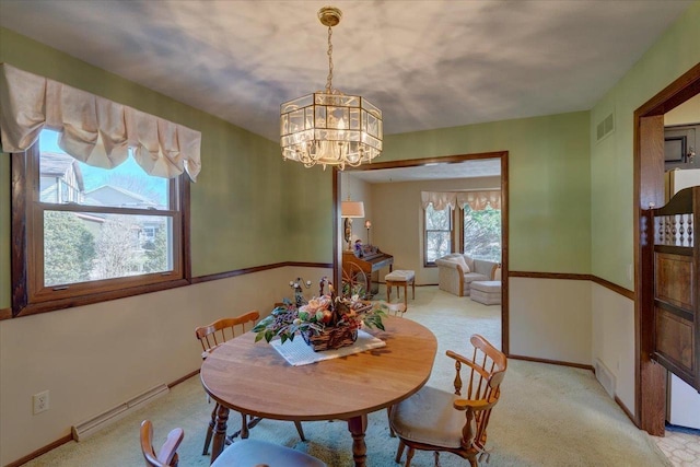 dining area with visible vents, light carpet, a baseboard heating unit, an inviting chandelier, and baseboards