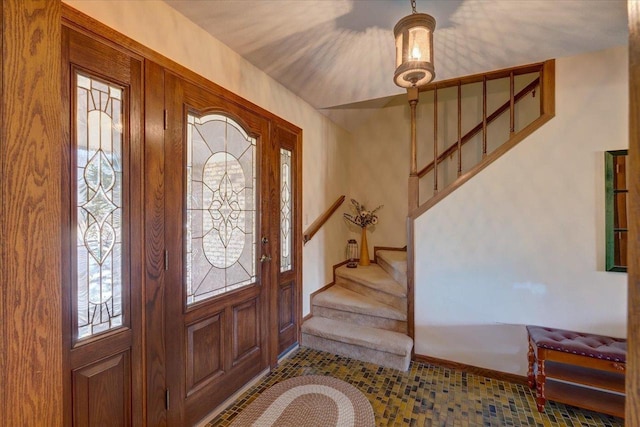 entryway featuring stairs and baseboards