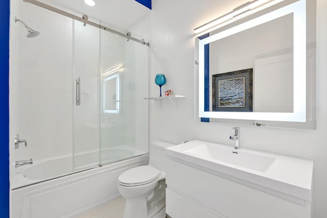 bathroom featuring enclosed tub / shower combo, vanity, toilet, and tile patterned floors