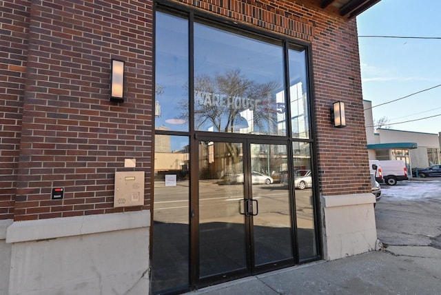 entrance to property featuring brick siding