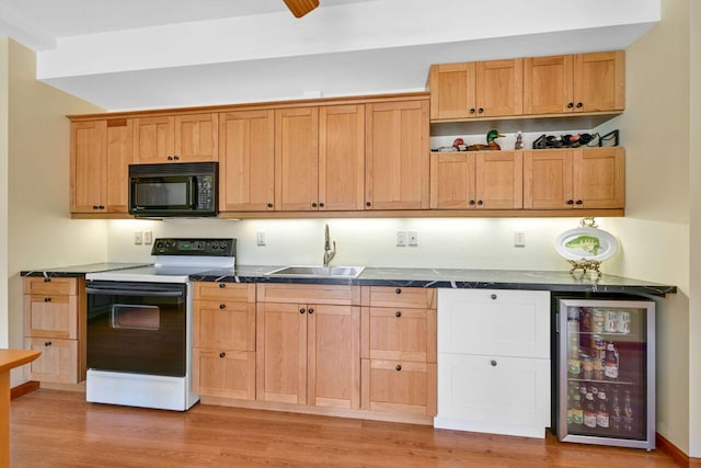 kitchen with beverage cooler, range with electric cooktop, dark countertops, black microwave, and a sink