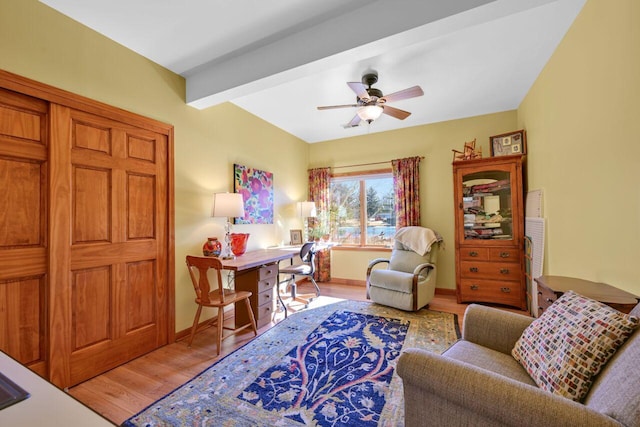 office area with ceiling fan, beamed ceiling, light wood-style flooring, and baseboards