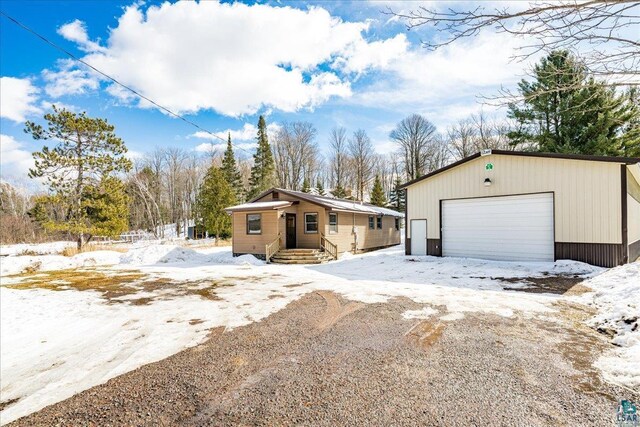 43240 County Highway D, Cable, WI 54821 - snow covered property featuring a garage and an outdoor structure
