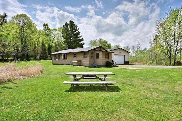 43240 County Highway D, Cable, WI 54821 - rear view of property featuring a detached garage, an outbuilding, and a yard