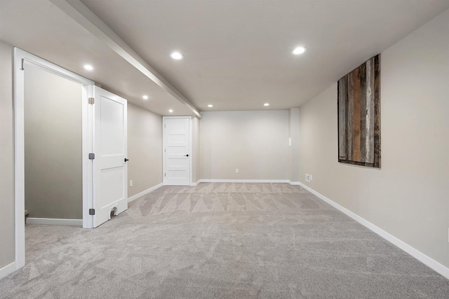 spare room featuring baseboards, recessed lighting, and light colored carpet