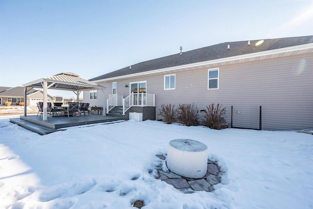 snow covered property with a gazebo