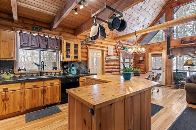 kitchen featuring brown cabinets, glass insert cabinets, butcher block countertops, light wood-type flooring, and dishwasher