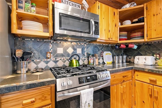 kitchen featuring stainless steel appliances, open shelves, brown cabinetry, and backsplash