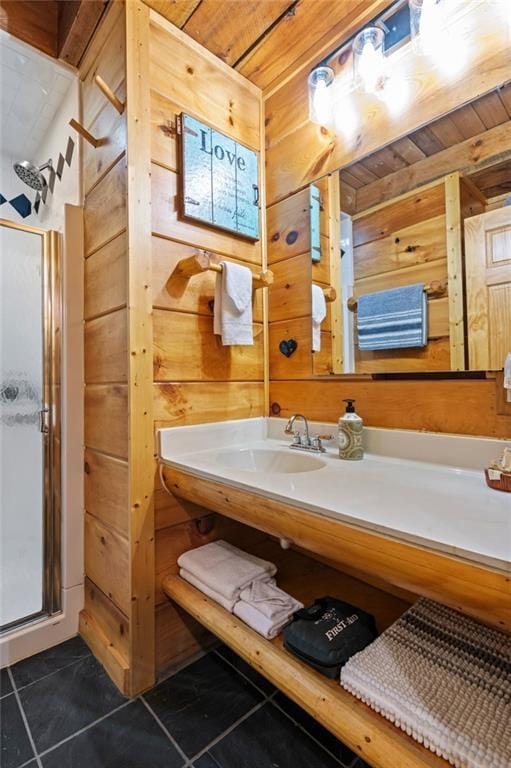 bathroom featuring wooden walls, a shower stall, and tile patterned floors