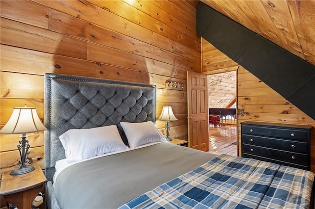 bedroom with wood finished floors and wooden walls