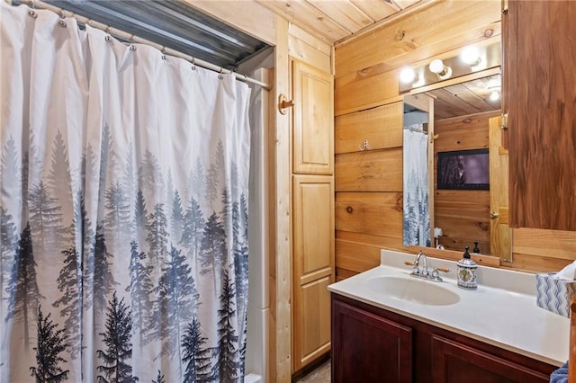 bathroom featuring a shower with shower curtain, wooden ceiling, wooden walls, and vanity