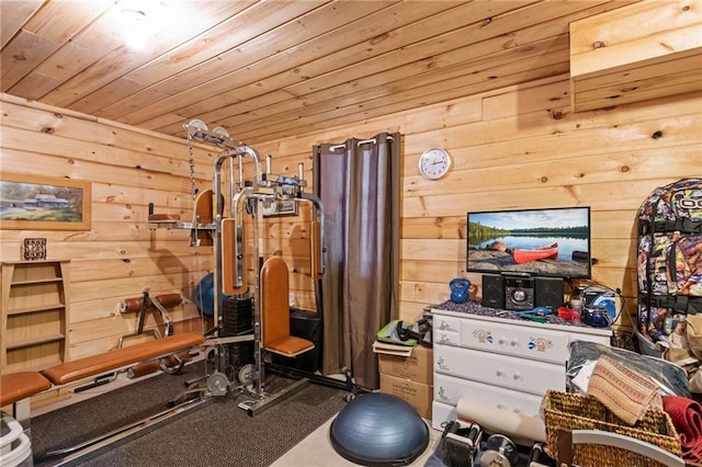 exercise area with wood ceiling and wooden walls