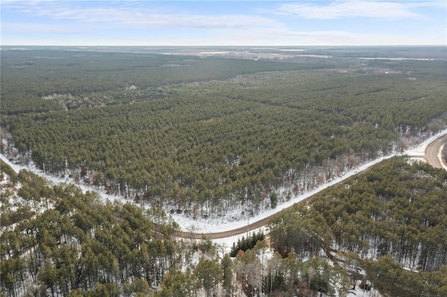 drone / aerial view with a wooded view