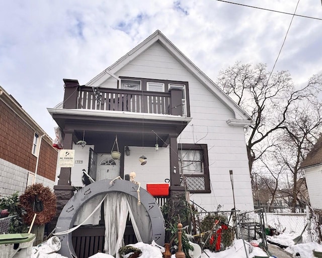 view of front facade with a balcony and fence