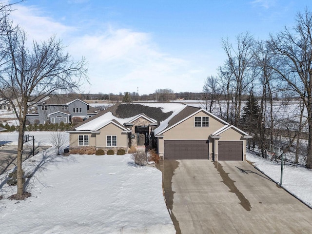 view of front of home featuring driveway, stone siding, and a residential view