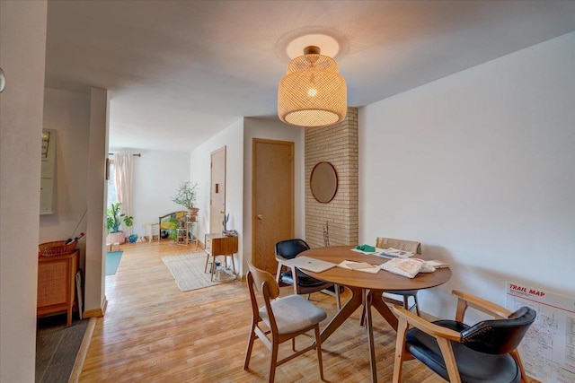 dining space featuring light wood finished floors