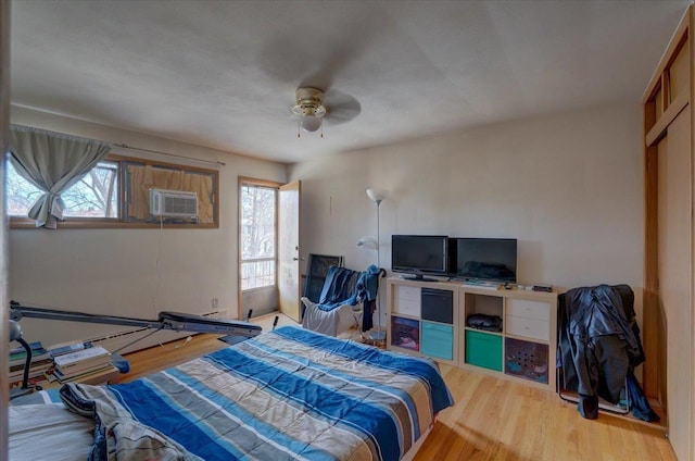 bedroom featuring cooling unit and wood finished floors