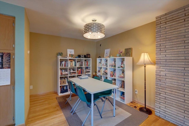 office with baseboards and light wood-style flooring