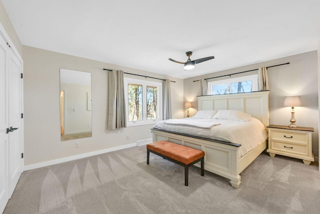 carpeted bedroom with a ceiling fan, baseboards, visible vents, and a closet