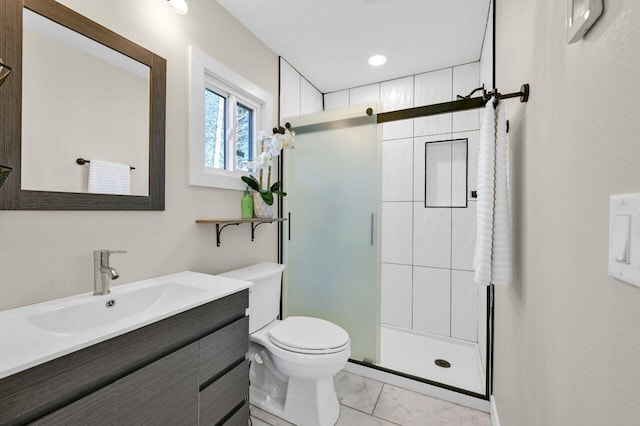 bathroom featuring vanity, toilet, and a stall shower