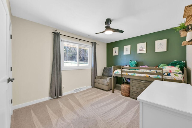 bedroom featuring visible vents, light carpet, baseboards, and ceiling fan