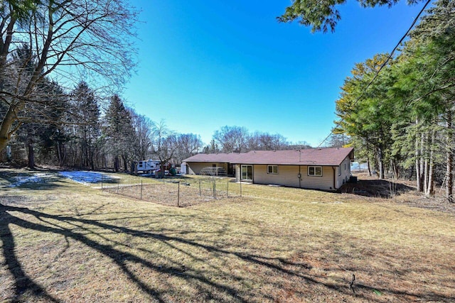 exterior space with a lawn and fence