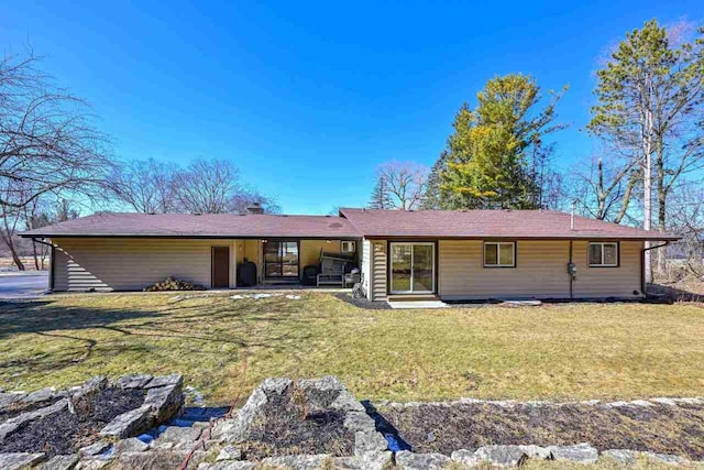 rear view of property with a yard