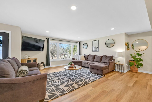 living area with recessed lighting, baseboards, and wood finished floors