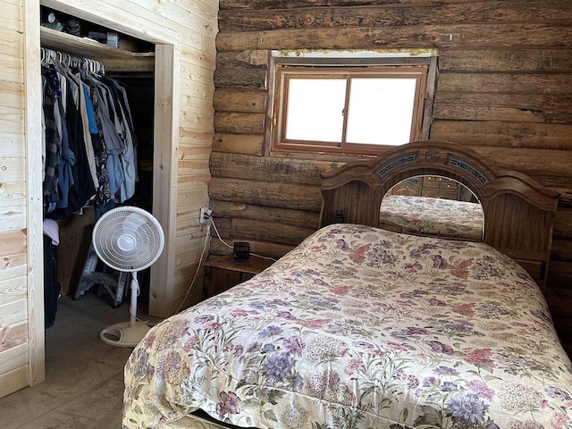 carpeted bedroom featuring a closet and log walls