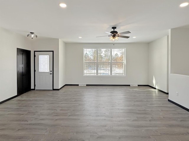 interior space featuring light wood finished floors, recessed lighting, visible vents, a ceiling fan, and baseboards