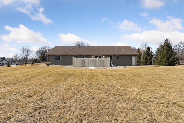 rear view of property with a yard