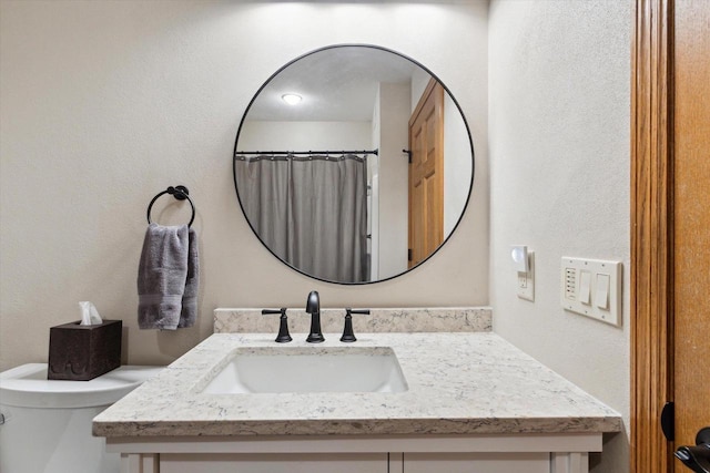 full bathroom with toilet and vanity