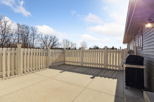 view of patio featuring area for grilling and fence