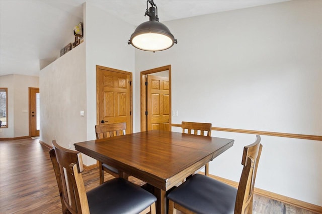 dining area with baseboards and wood finished floors