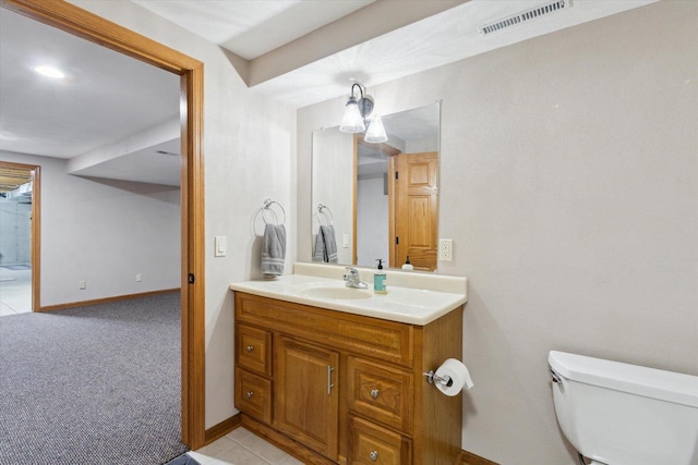 half bathroom featuring toilet, baseboards, visible vents, and vanity