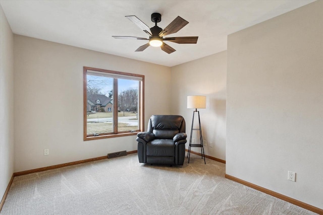 sitting room with carpet, visible vents, ceiling fan, and baseboards