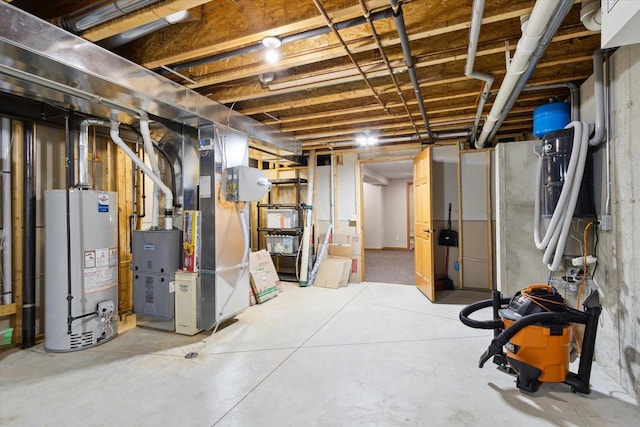 unfinished basement featuring gas water heater and heating unit