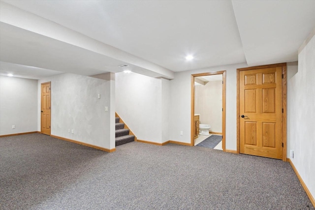 finished basement with carpet floors, stairs, baseboards, and recessed lighting