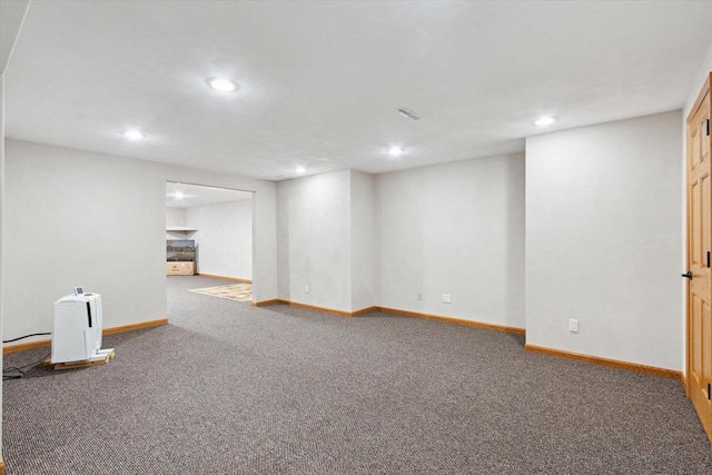 finished basement featuring carpet floors, recessed lighting, a fireplace, and baseboards