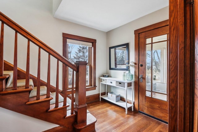 entrance foyer featuring stairway and wood finished floors